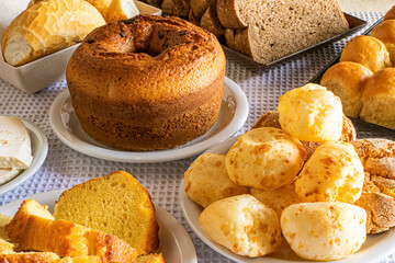 Breakfast table in hotel, with sweets, cakes, cheese bread and bread. Brazilian Mineira food and...