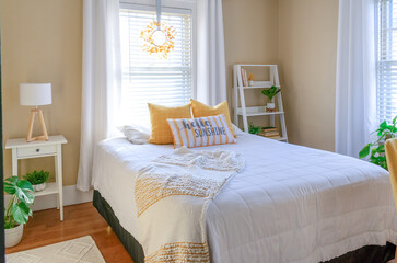 Stylish small bedroom decorated in yellow and white - 392757929