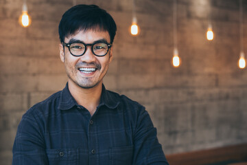 portrait young asian man wear eye glasses smiling cheerful look thinking position with perfect...