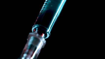 Blood is taken for tests with a medical syringe.