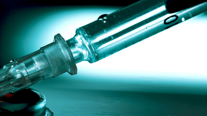 Drug addict prepares another dose of drugs with syringe