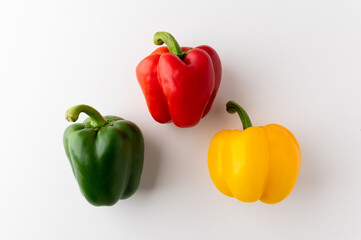 Colorful raw red yellow green of bell pepper above view on isolated white background. Healthy vegetables and food.