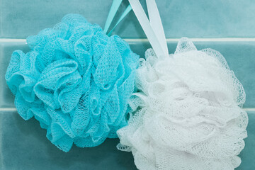blue and white washcloths hang on a hook in the bathroom. Close-up