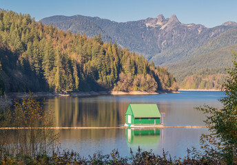 Beautiful autumn landscape of the boathouse at Cleveland Dam reservoir near North Vancouver,...