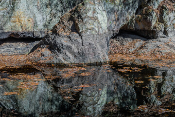 Large boulders on side of shallow river
