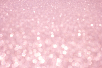 Defocused abstract pink twinkle light background.  Pink glittery bright shimmering background use as a design backdrop.