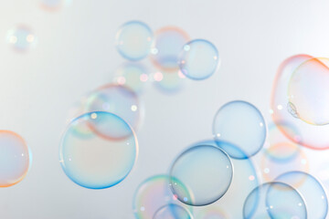 Beautiful shiny colorful soap bubbles floating in the air. Abstract, Natual fresh summer background.