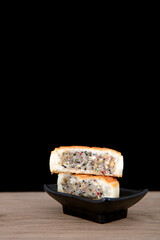Moon cakes laid out on the table in front of black background