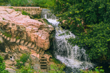 Beautiful landscape of waterfalls under trees during golden hour