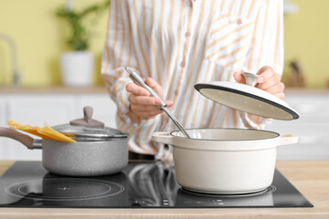 Woman cooking dinner in kitchen