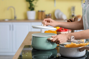 Woman cooking dinner in kitchen