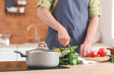 Man cooking dinner in kitchen