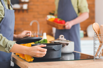 Young couple cooking dinner in kitchen
