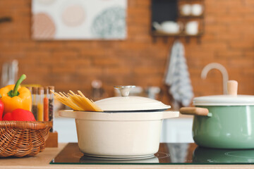 Fototapeta na wymiar Cooking pots on stove in kitchen