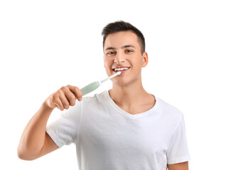 Young man with electric tooth brush on white background