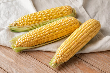 Fresh corn cobs on table