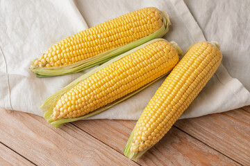 Fresh corn cobs on table