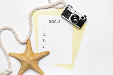 Empty to do list with photo camera on white background