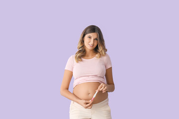 Beautiful pregnant woman with test on color background