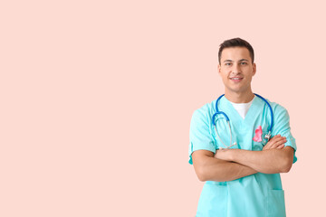 Doctor with pink ribbon on color background. Breast cancer awareness concept