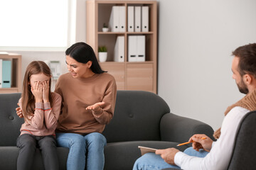 Unhappy family visiting psychologist in office