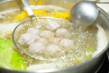 cooking pork balls in a hot pot