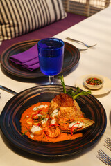closeup of fried rice with red curry seafood on table at poolside restaurant