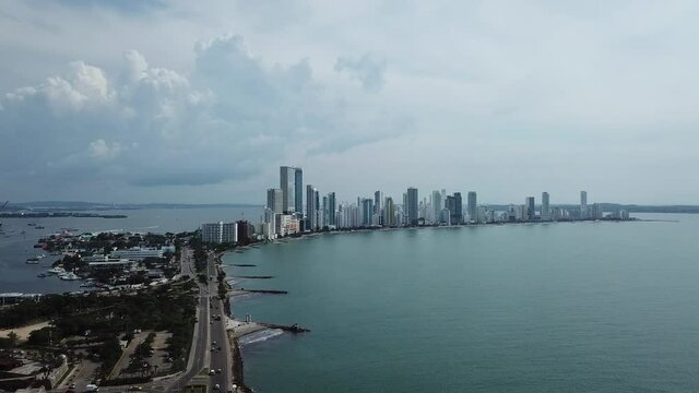 Sky Line of Cartagena from faraway filmed by drone. Costal road and port bay of Cartagena. 