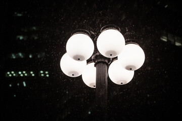 Winter Snow falling Under an Urban City Street Light