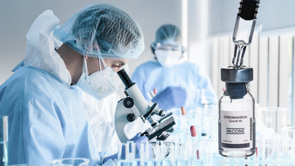 coronavirus covid-19 vaccine bottle on background of research laboratory