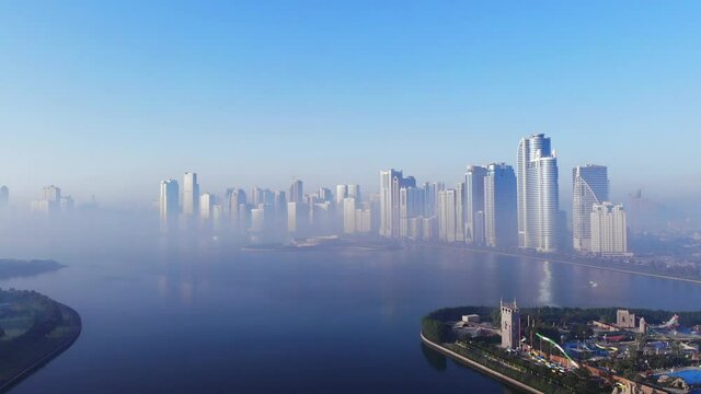 View from above of Sharjah's Khalid Lake, Sharjah Skyline on a foggy morning, Fog in Gulf, United Arab Emirates, 4K video
