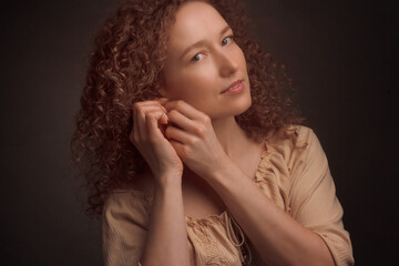 Studio portrait of a young woman with curly hair