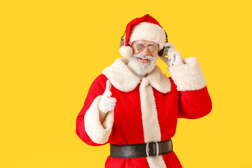 Cool Santa Claus listening to music on color background