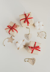 Gift boxes made from craft paper with red ribbon on white background. Top view, flat lay composition. - 392786541