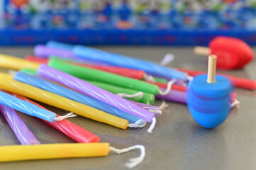 Hanukkah Menorah candelabra, Dreidels (spinning top) and colorful candles holiday background.