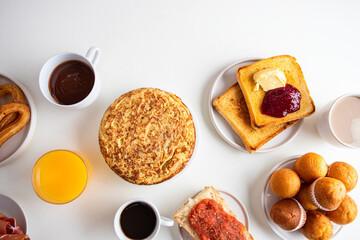 Tortilla, bruschetta with jamon and tomatoes,   crusty toast with butter and jam , Spanish muffin, coffee and orange juice. Typical breakfast in Spain