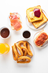 Tortilla, bruschetta with jamon and tomatoes,   crusty toast with butter and jam , Spanish muffin, coffee and orange juice. Typical breakfast in Spain