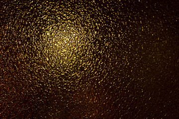 Gold glass, artistic design. Texture and abstract background of black or gold colored glass and light. selective focus