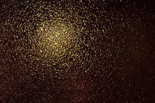 Gold Glass, Artistic Design. Texture And Abstract Background Of Black Or Gold Colored Glass And Light. Selective Focus
