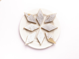 Kaju katli / kaju barfi is a diamond shape indian sweet made with using cashew stock image. 