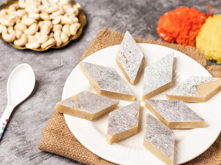Kaju katli / kaju barfi is a diamond shape indian sweet made with using cashew stock image. 