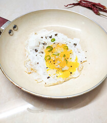 fried egg in a frying pan sunny side up