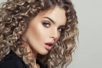 Nice model woman with curly hair on white, fashion beauty portrait