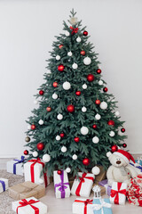 New Year's card interior of the white room red decor and Christmas tree with gifts