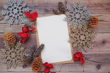 Christmas greeting card with decoration on wooden background.