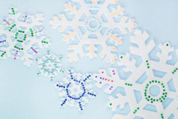White snowflakes with sparkles on a blue background.