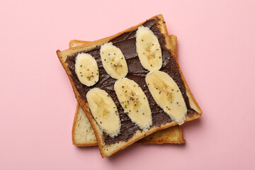 Sweet toast with banana on pink background