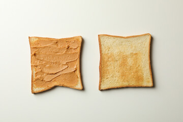 Sweet toast with peanut butter on gray background