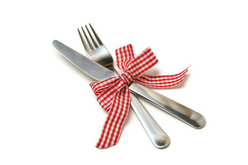 Cutlery with checkered bow isolated on white background