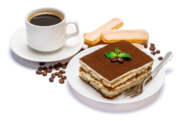 Traditional Italian Tiramisu dessert square portion on ceramic plate, savoiardi cookies and cup of fresh espresso coffee isolated on white background with clipping path
